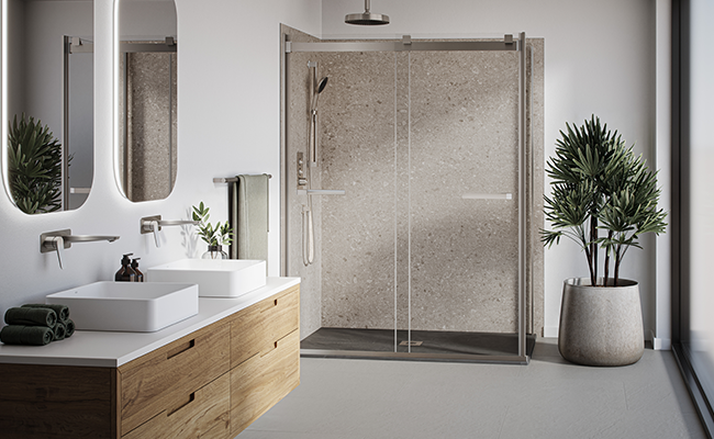A beige shower space with chrome Kalia faucets.